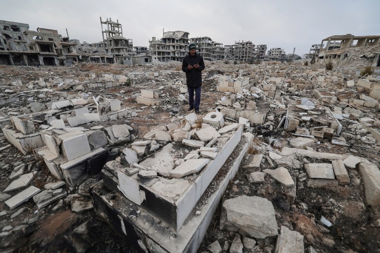 Ibrahim Daraji, who said he is still mourning two sons, one disappeared into Sednaya prison and another lost to a mortar strike in Al-Yarmouk camp, prays at damaged Martyrs cemetery where his son is buried at al-Yarmouk Palestinian refugee camp, after fighters of the ruling Syrian body ousted Bashar al-Assad, in Damascus, Syria December 22, 2024. REUTERS/Zohra Bensemra