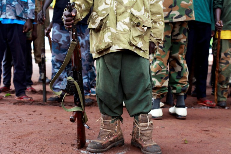 A former child soldier holds a gun as they participate in a child soldiers' release ceremony, outside Yambio, South Sudan, August 7, 2018. REUTERS/Andreea Campeanu TPX IMAGES OF THE DAY