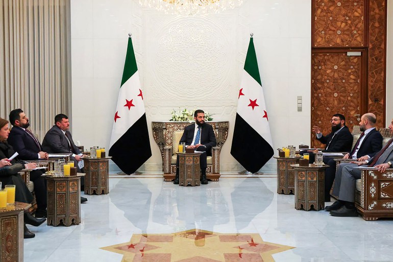 This handout picture released by the Syrian Presidency shows Syria's interim leader Ahmed al-Sharaa (C) meeting with members of the committee to draft a constitutional declaration for the country's transition after the overthrow of longtime ruler Bashar al-Assad, in Damascus on March 2, 2025. The new authorities are focused on rebuilding Syria and its institutions after Assad's removal on December 8, ending more than half a century of his family's iron-fisted rule and 13 years of devastating war. The seven-member committee would "submit its proposals to the president", the presidency said in a statement, without specifying a timeframe. (Photo by Syrian Presidency / AFP) / RESTRICTED TO EDITORIAL USE - MANDATORY CREDIT "AFP PHOTO / SYRIAN PRESIDENCY" - NO MARKETING NO ADVERTISING CAMPAIGNS - DISTRIBUTED AS A SERVICE TO CLIENTS