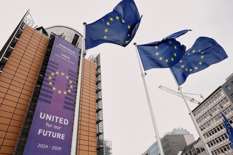 European Union flags flap in the wind outside of EU headquarters in Brussels, Belgium, Tuesday, May 27, 2025. (AP Photo/Omar Havana)