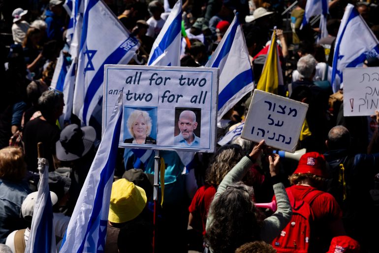 JERUSALEM, ISRAEL - MARCH 23: Protesters hold signs with photos of attorney general Gali Baharav Miara and Israel's intelligence Director Ronen Bar during a protest against the Israeli government outside the Prime Minister's office on March 23, 2025 in Jerusalem. Israelis are taking to the streets calling for a new ceasefire in Gaza and to protest against what they consider to be an attack on the country's democracy by the rightwing coalition of Benjamin Netanyahu's government. (Photo by Amir Levy/Getty Images)