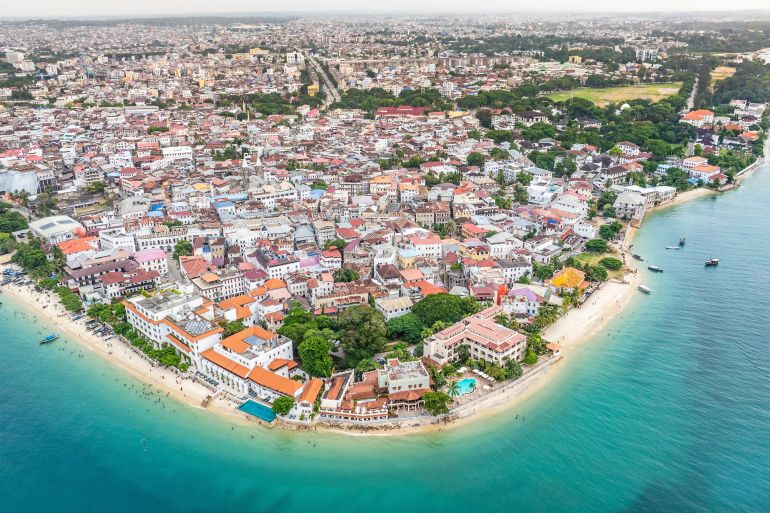 Aerial city view of area around the historic Stone Town, the oldest part of Zanzibar Town on Unjuja island, Tanzania with historic buildings and beaches ; Shutterstock ID 2432295431; purchase_order: aljazeera ; job: ; client: ; other: