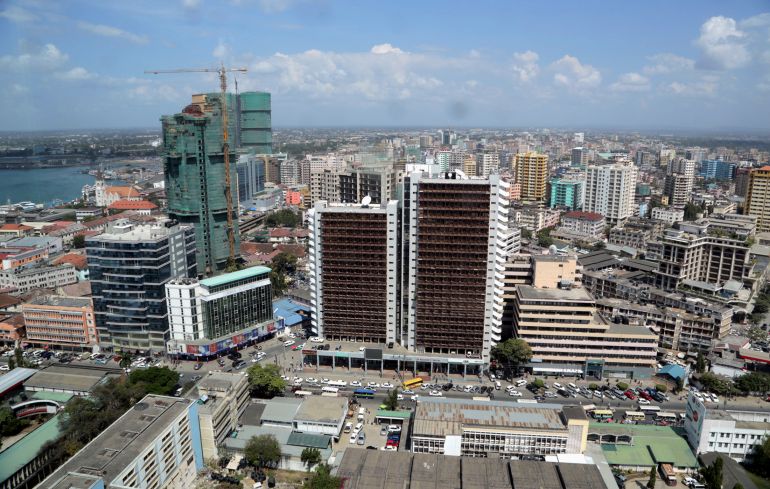 A general picture shows the skyline of Tanzania's port city of Dar es Salaam, July 12, 2013. Tanzania's commercial capital looks like a boom town even before cash rolls in from gas discoveries that in the next few years could make the east African nation a major energy exporter. Glass-clad tower blocks pierce Dar es Salaam's sky-line and more are emerging from noisy building sites. Billboards advertise high-definition televisions and other electronics to a new middle class, who crowd brand new shopping malls. REUTERS/Andrew Emmanuel (TANZANIA - Tags: SOCIETY BUSINESS ENERGY)