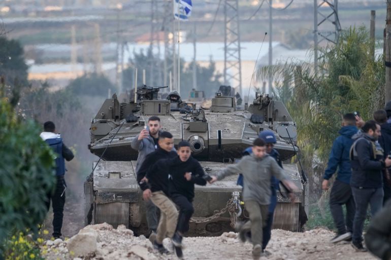 Israeli soldiers drive a tank towards the occupied West Bank of Jenin camp, during an ongoing army operation, Feb. 23, 2025. (AP Photo/Majdi Mohammed)