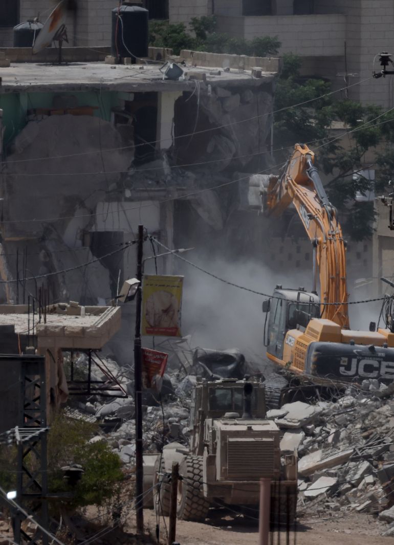 epa12208298 Israeli army excavators demolishes buildings during an Israeli military operation in Jenin refugee camp, near the West Bank city of Jenin , 01 July 2025. According to the Palestinian news agency Wafa, Israeli forces continued their military operation in the city of Jenin and the camp for the 161st consecutive day. EPA/ALAA BADARNEH